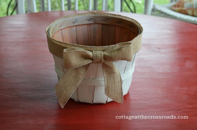 Apple basket painted white with a burlap bow