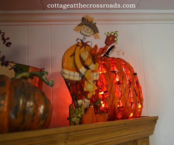 Scarecrow and lighted pumpkin