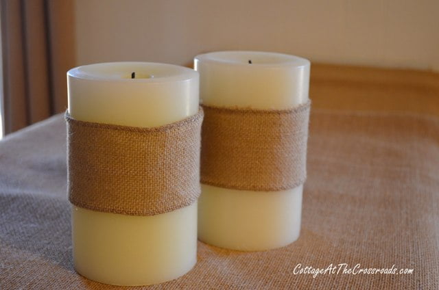 White candles wrapped in burlap