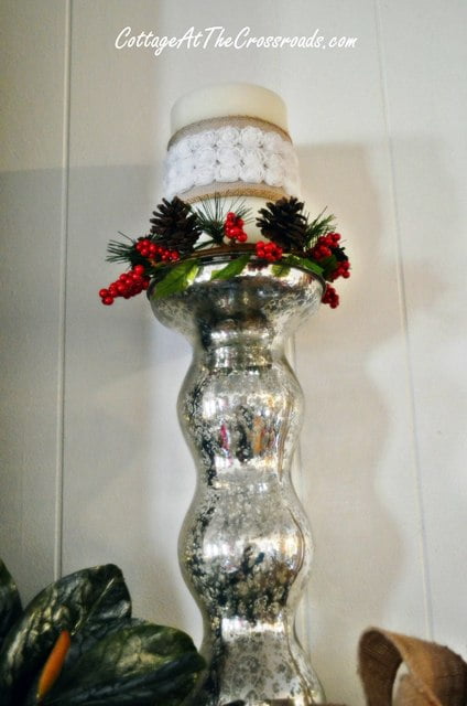 Decorated candle on mercury glass candle holder
