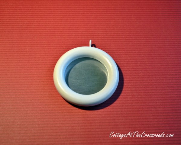 White curtain ring with metallic paper on the back