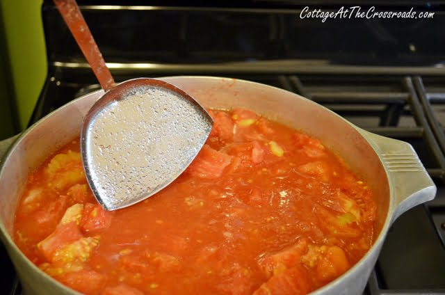 Constantly stir tomatoes on medium high heat.
