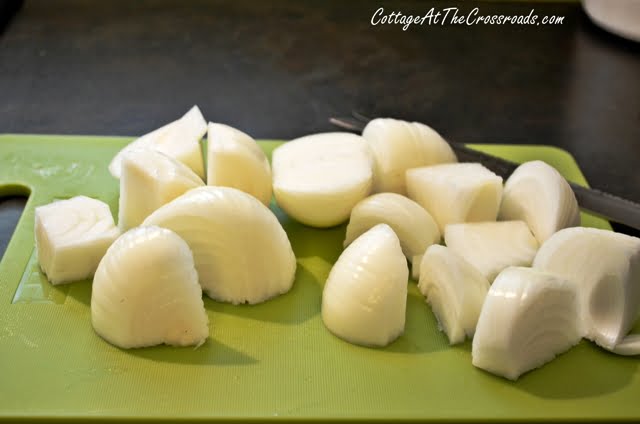 Chop onions on cutting board.