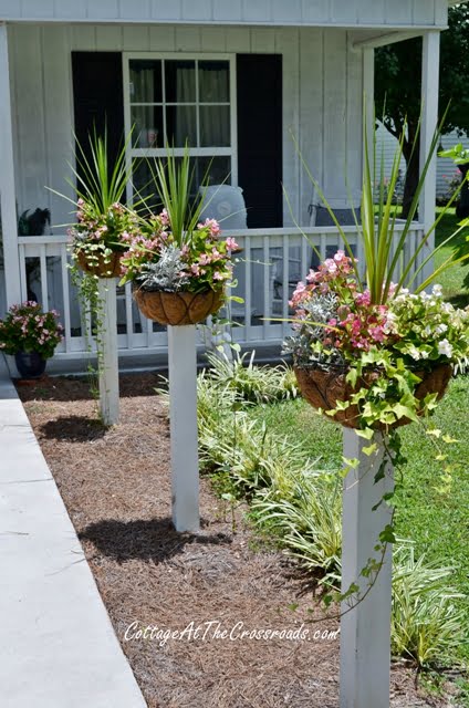 Flower baskets on top of wooden posts