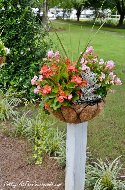 Flower baskets on wooden posts