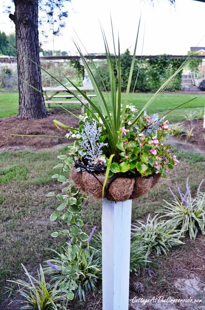 Flower baskets on wooden posts