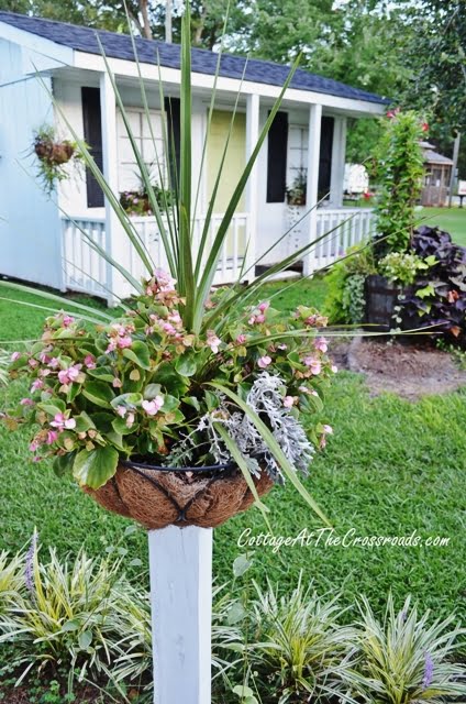 Flower baskets on wooden posts