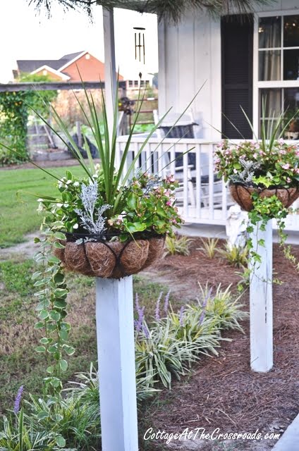 Flower baskets on wooden posts
