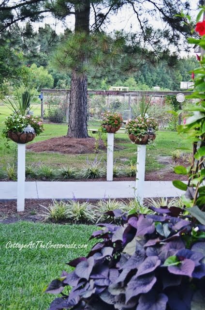 Flower baskets on wooden posts