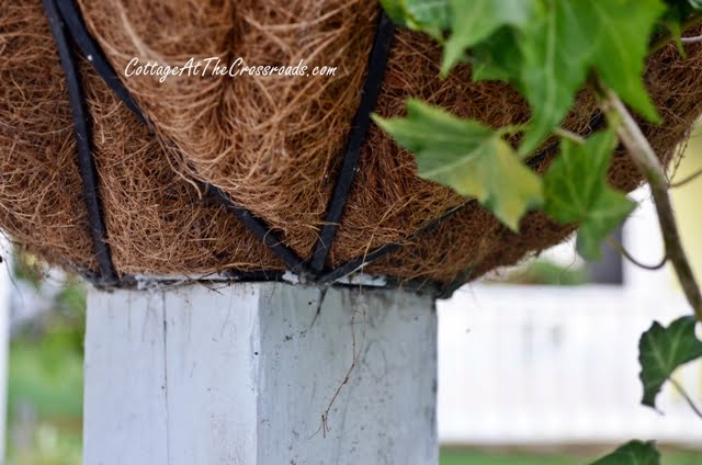 Flower baskets mounted on wooden posts