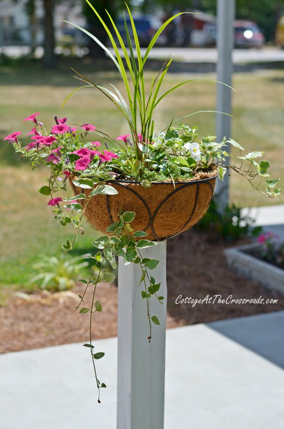 Flower baskets on wooden posts