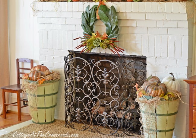 Fall mantel with magnolia wreath and painted bushel baskets | cottage at the crossroads