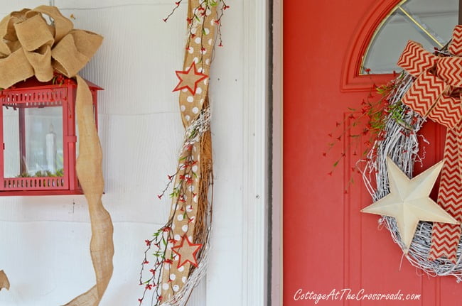 Patriotic door display and decorated garland | cottage at the crossroads