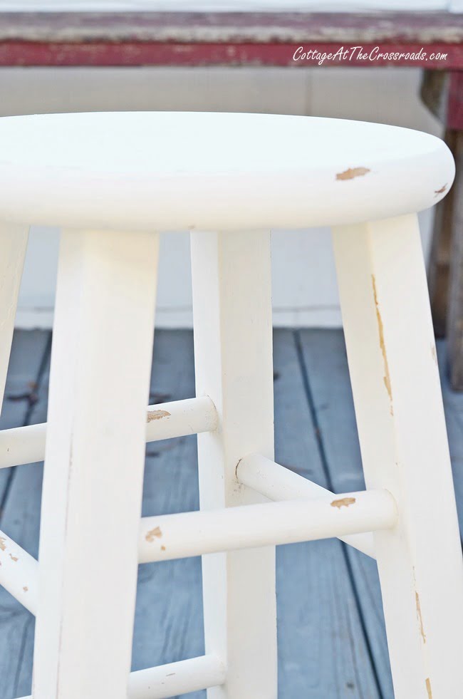 An ordinary wooden stool gets a cottage look when painted with chalky paint | cottage at the crossroads