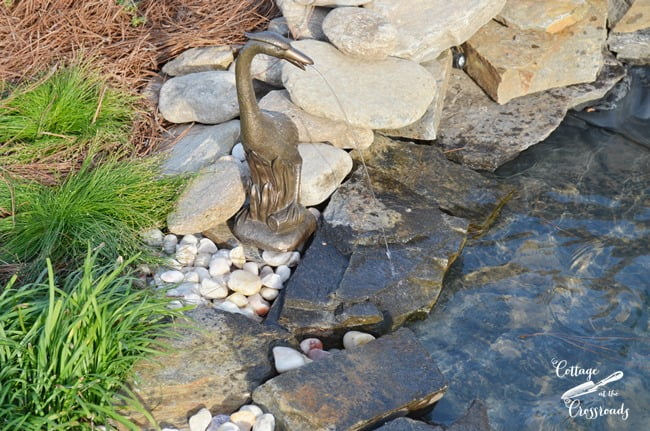 Heron spitter around a garden waterfall | cottage at the crossroads