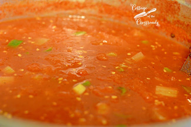 Using fresh tomatoes from the garden to make homemade shrimp creole sauce