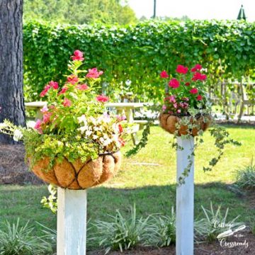 Flower baskets mounted on wooden posts