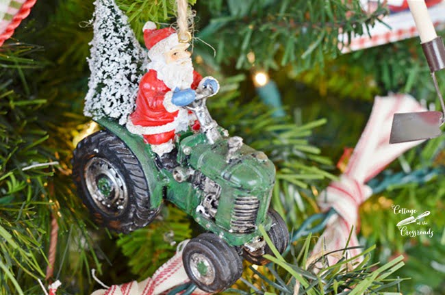 Santa on a tractor christmas ornament