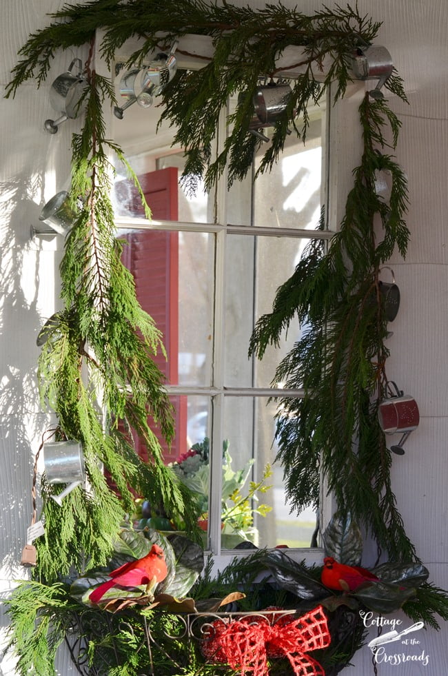 Fresh christmas garland around an old mirror