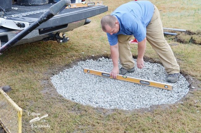 Leveling the pebbles in the base of belgard fire pit install