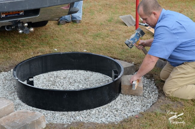 Leveling the stones in a belgard fire pit installation