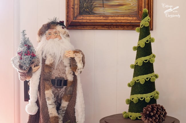 Woodland santa beside a pom pom christmas tree