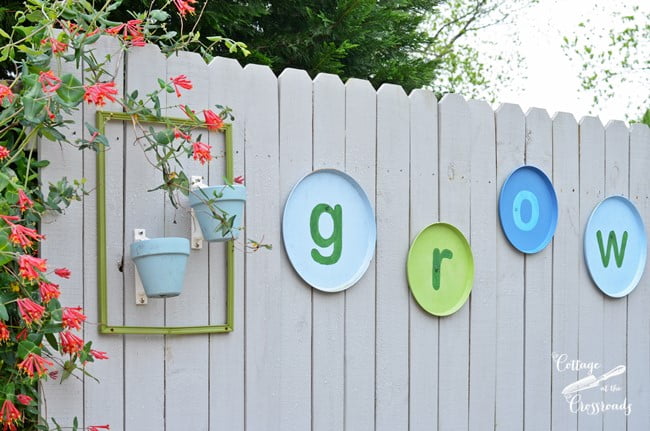 The word grow hanging on wooden fence