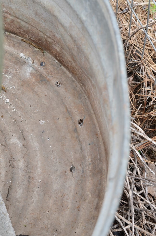 Holes drilled in a galvanized tub