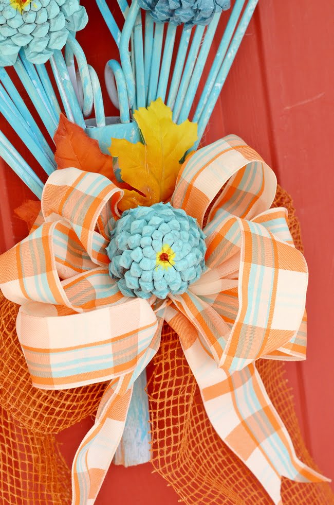 Bow and pine cone zinnia on a fall rake wreath