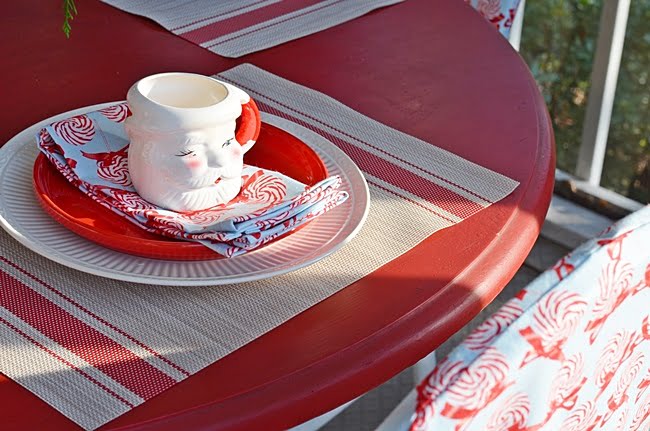 Vintage santa mugs used on a table on a christmas porch