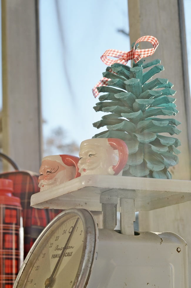 Vintage santa mugs on a christmas porch