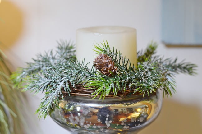 Greenery and candle on top of a silver candlestick | cottage at the crossroads