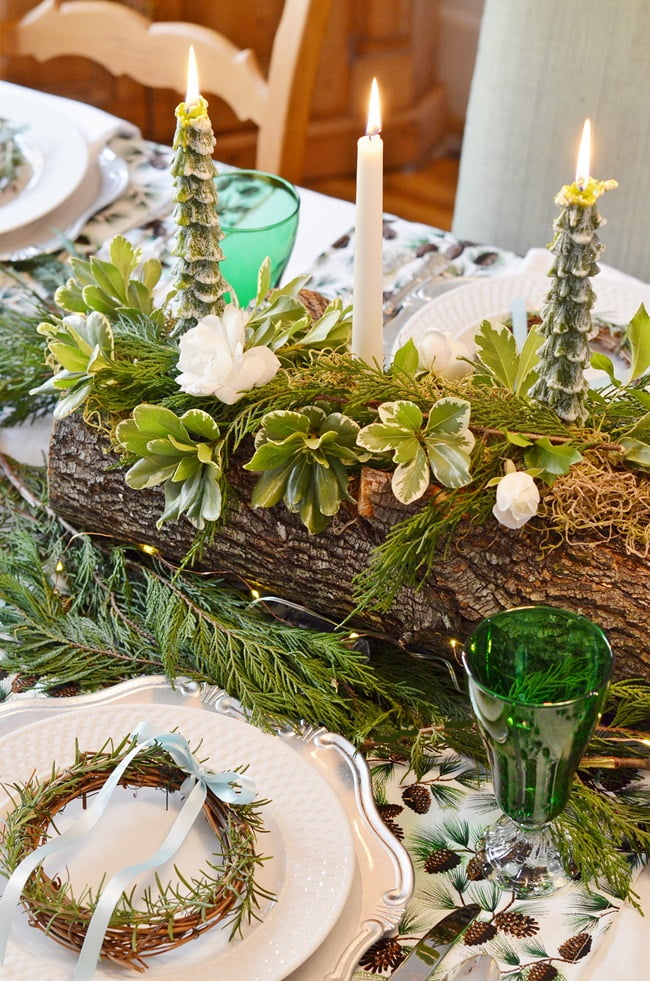 Greenery and roses on a yule log | cottage at the crossroads