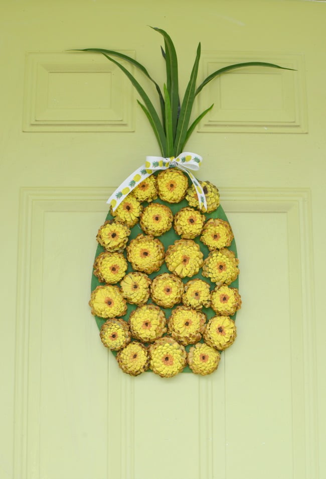 A pineapple wreath made with painted pine cones
