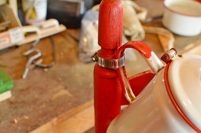 Clamp used to attach an enamelware coffee pot to a chair