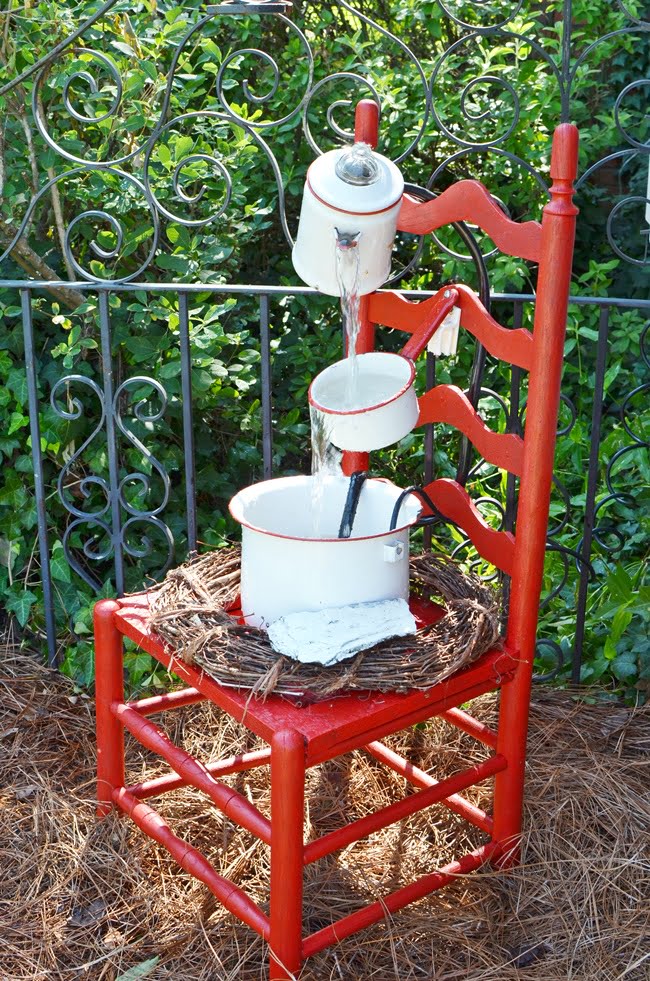 Red and white vintage enamelware chair fountain