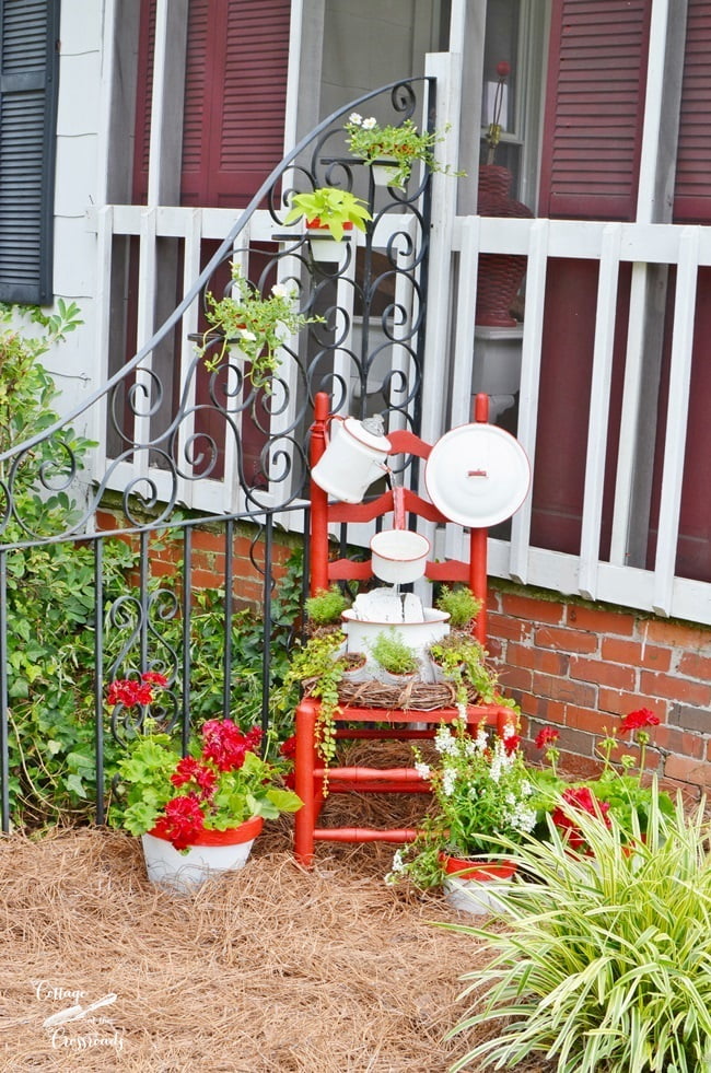 Red and white enamelware chair fountain from cottage at the crossroads