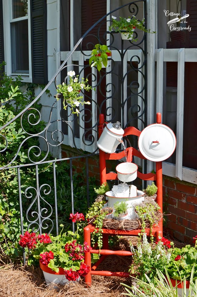 Vintage red and white enamelware chair fountain from cottage at the crossroads