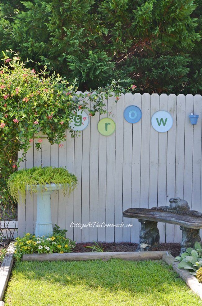 Diy garden grow sign on a wooden fence