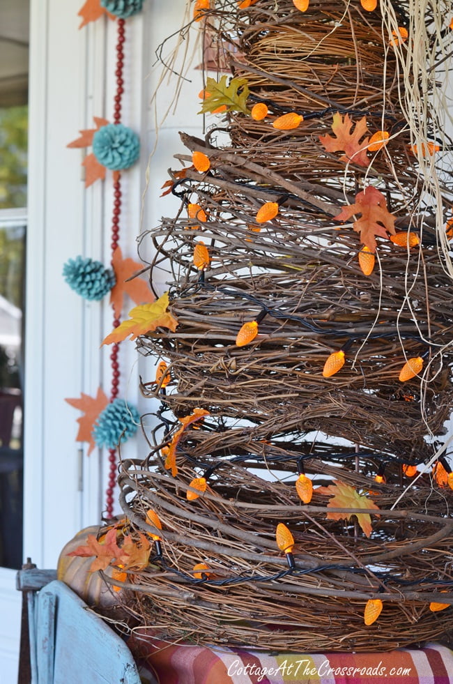 Handmade grapevine tree used in decorating an autumn front porch