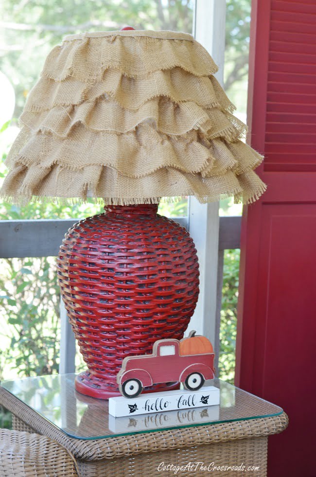 Red wicker lamp with a burlap ruffled shade