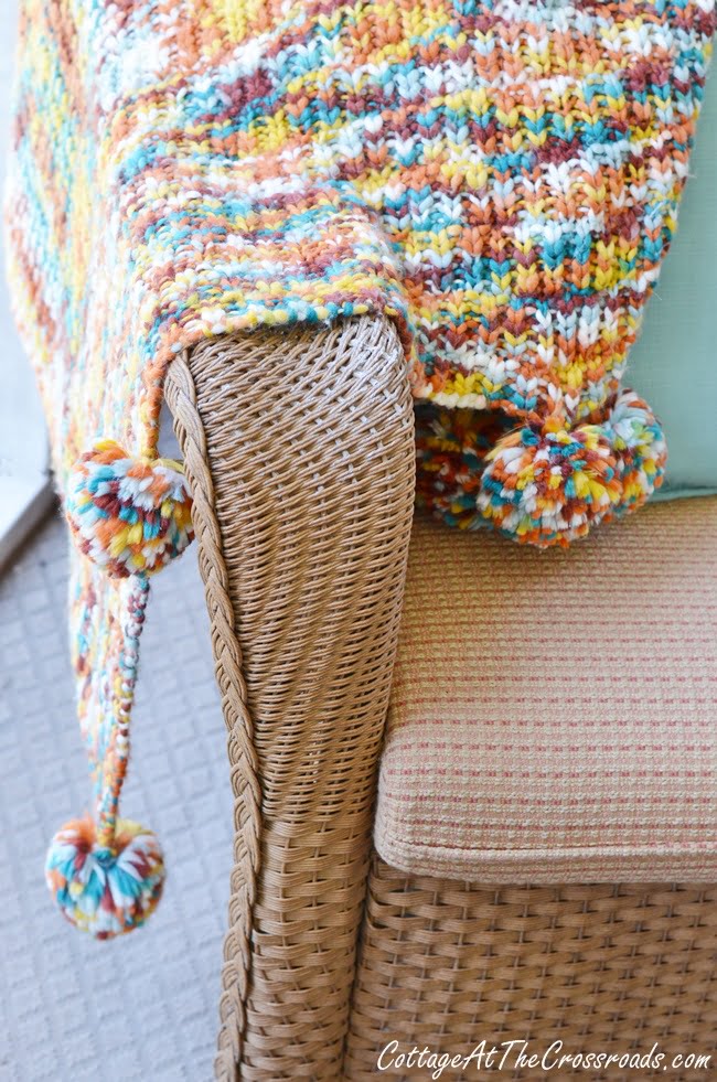 Fall pom pom throw on an autumn porch