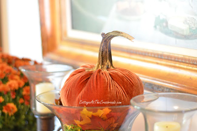 Orange velvet pumpkin in a fall farmhouse dining room
