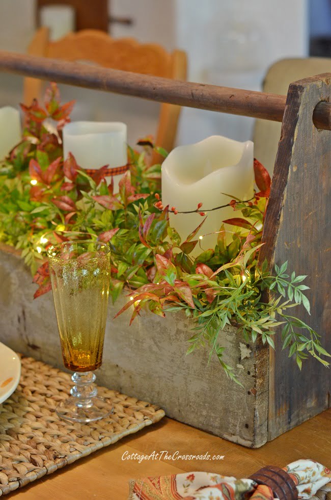 Nandina branches mixed in with faux greenery on a fall tablescape