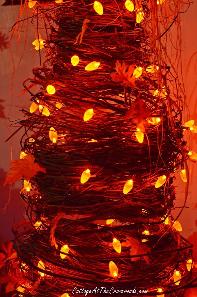 Orange lights on a grapevine tree at night