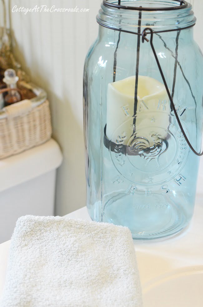 Blue mason jar candle holder used in a fall bathroom update