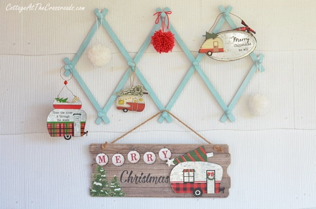 Vintage camper ornaments hanging on a vintage wooden rack