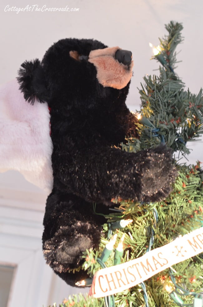 Black bear tree topper on a camping themed christmas porch