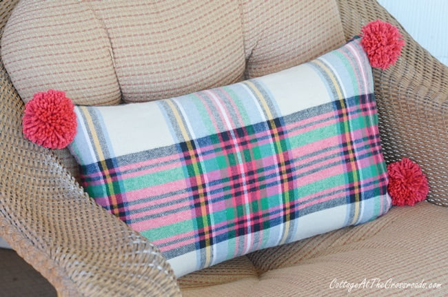 Plaid pillow on a christmas porch