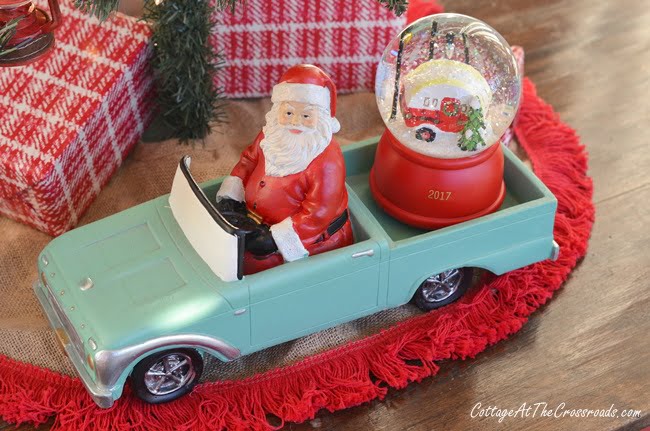 Santa in a vintage car on a christmas porch